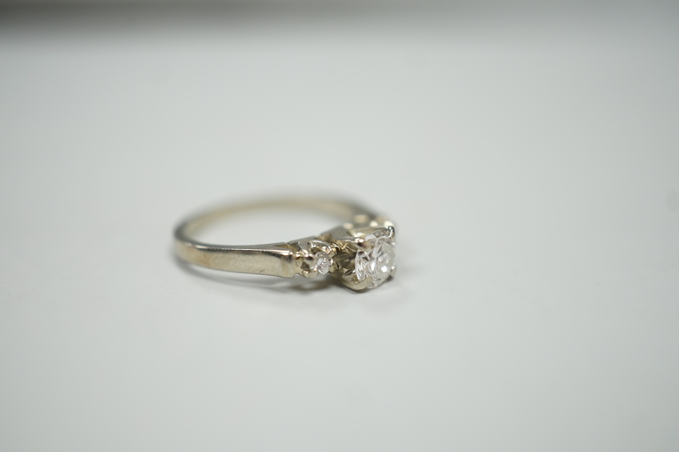 A Canadian Birks 18k white metal and single stone diamond ring, with diamond set shoulders, size H, gross weight 2.7 grams
